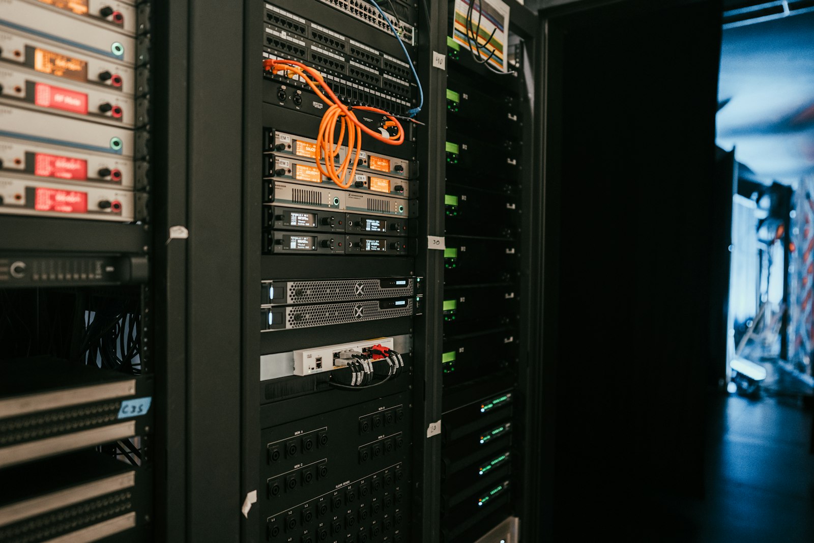 A server rack with patch cables and network equipment, standing in for the backend systems that confirm a purchase before the Conversions API event is sent