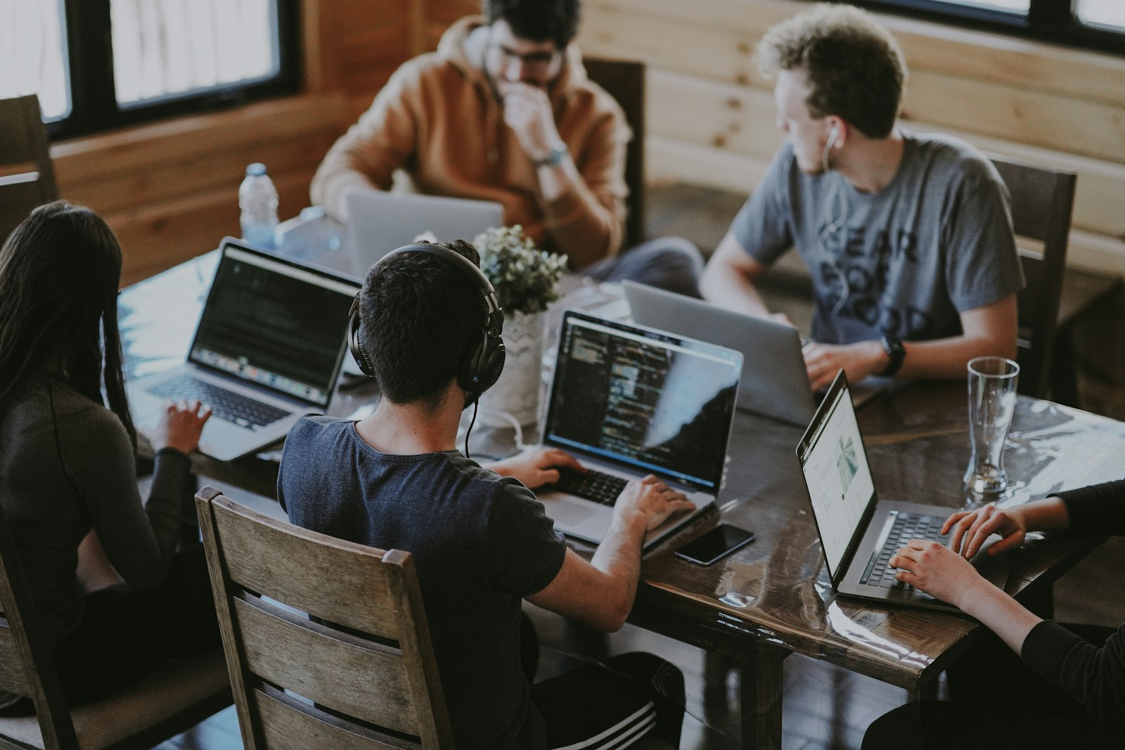 A marketing team collaborating around laptops in an open office