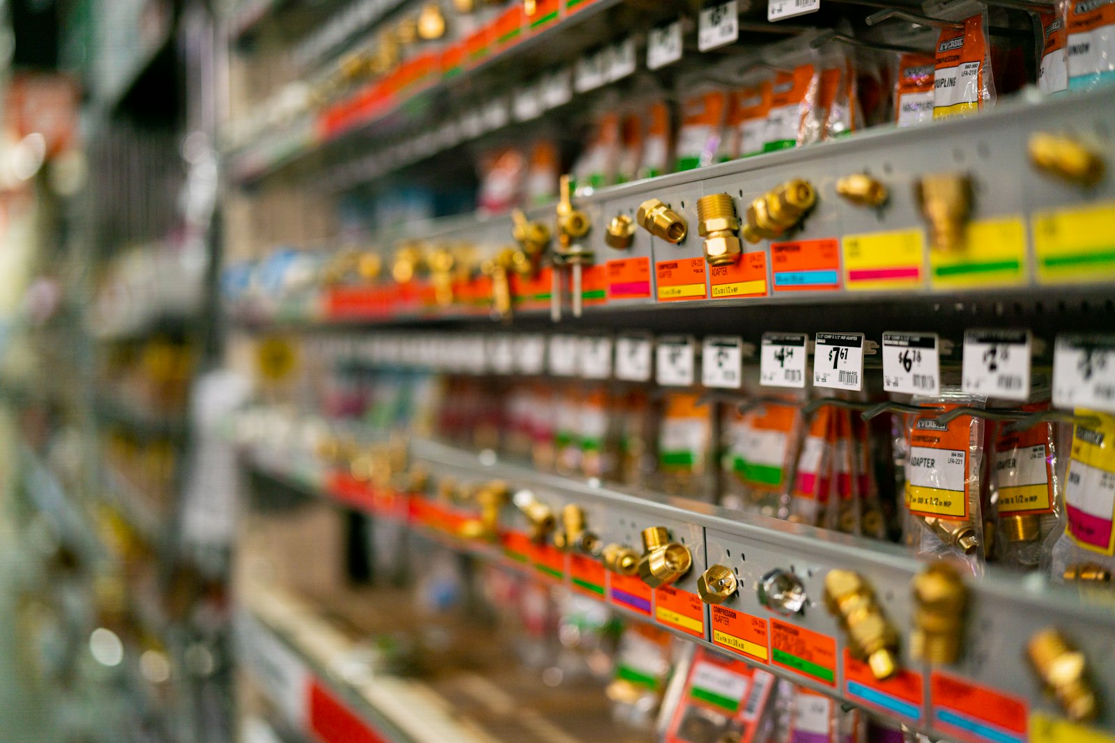 Retail shelf packed with hundreds of small hardware SKUs and price tags, a reminder that most catalog items sit in the long tail